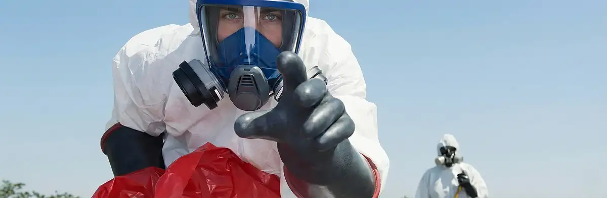 sewage clean up technician wearing protective gear handling biohazard materials in Des Moines, IA