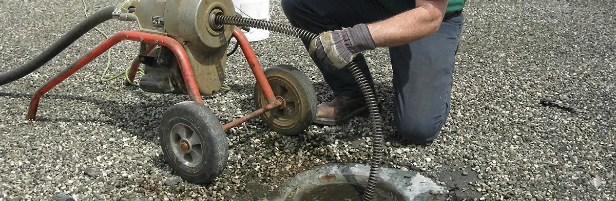 sewer rodding technician actively removing blockages from a sewer line in Des Moines, IA