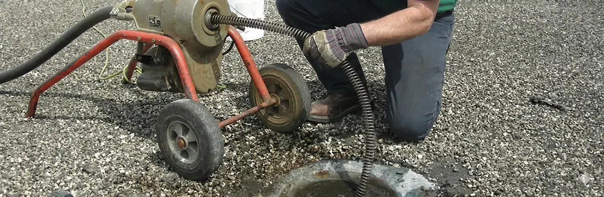 sewer rodding technician actively removing blockages from a sewer line in Des Moines, IA