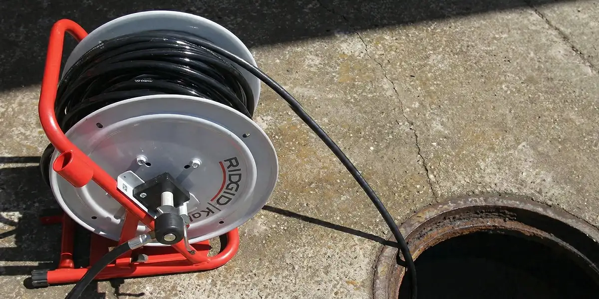 sewer rodding equipment prepared to clear clogged sewer lines in Des Moines, IA
